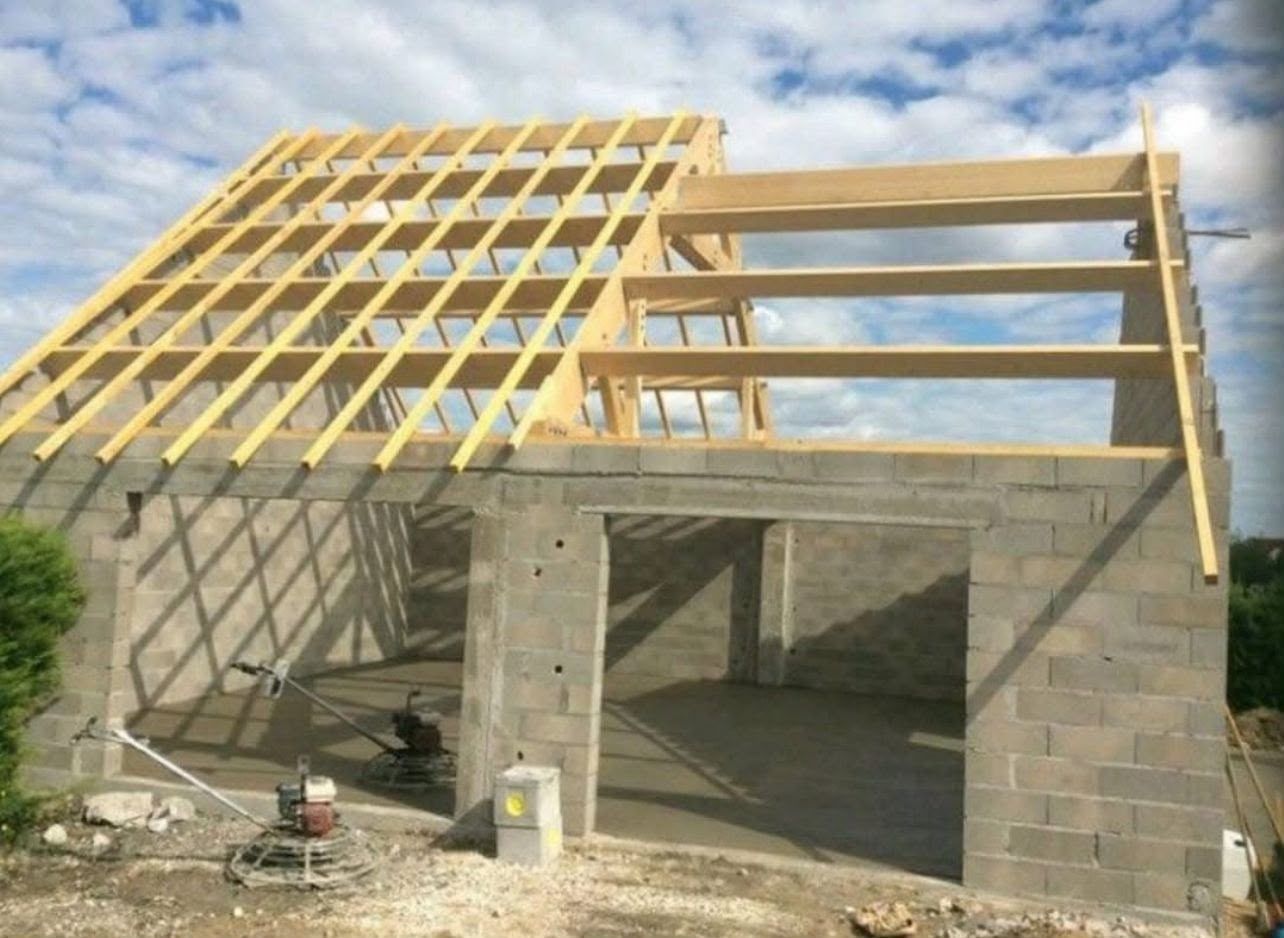 Extension en parpaings, charpente bois posée avant couverture. Chantier réel des équipes partenaires.